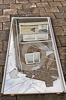 Broken mirror lying shattered on the ground