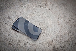 Broken mobile phone on the floor concrete. smartphone hitting the street