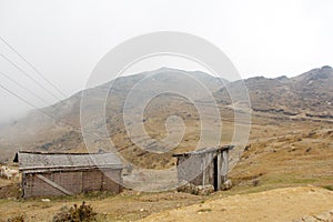 Broken mountain hut in the fog