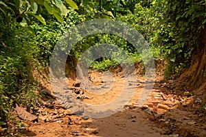 Broken mountain road after rain. Slippery and broken roads in the mountainous region of Bangladesh. Photo taken from Meghla,