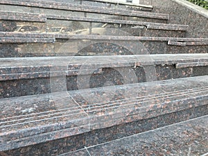 Broken nosing of an riser of an granite finished stair riser and treads which have three grooves for anti slippery purpose and photo