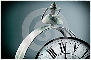 Broken old analog clock with glass and metal frame on wooden table, broken structure