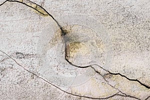 Broken old crack on the surface of a white cement dirty wall damaged concrete background