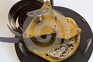 Broken old metallic clockwork mechanism on white background