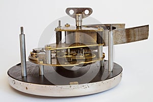 Broken old metallic clockwork mechanism on white background