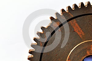 Broken old and rusty gear on white paper background