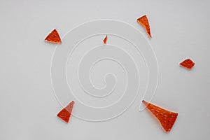 Broken orange glass background for your images isolated on a white background. A lot of shards fell apart