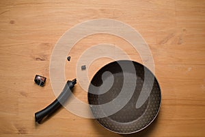Broken Pan Handle on Wooden Table
