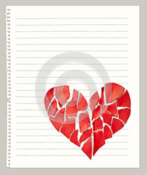 Broken paper heart on notebook page