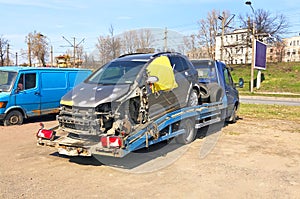 Broken passenger car in a small truck for evacuation and transportation