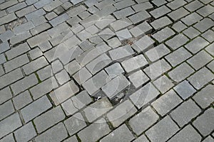 Broken pattern of street cobble pavement
