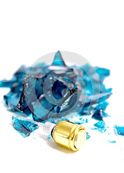 Broken  perfume bottle  on white