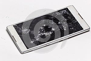 Broken phone with cracked screen on mobile device