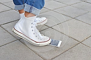 Broken phone screen from crushing by sneakers shoe