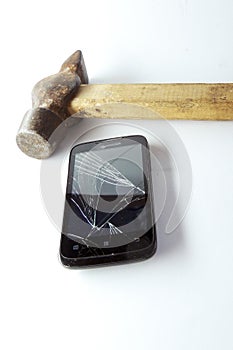 Broken phone screen and hammer