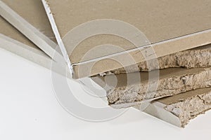 Broken pieces of plasterboard used in building activity and construction industry - Drywall material concept