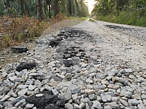Broken pieces of tarmac stone on the rural road