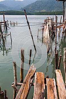 Broken pier of wooden planks in the Thai fishing village. Nature.