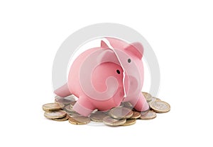 Broken piggy bank with coins on white background