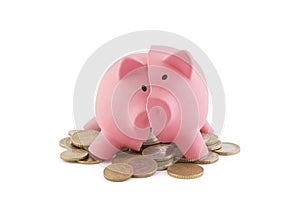 Broken piggy bank with coins on white background