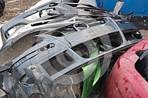 Broken plastic bumpers of cars for recycling during the day