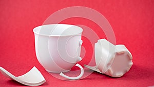 Broken Plate and dish or broken water glass on the on the red background The concept of accidents in the kitchen is dangerous for