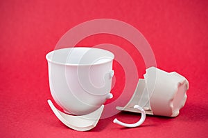 Broken Plate and dish or broken water glass on the on the red background The concept of accidents in the kitchen is dangerous for