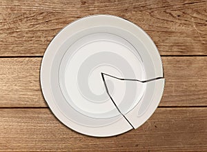 Broken plate on wood table