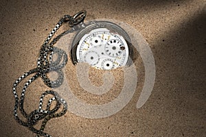 Broken Pocket Watch in the Sand