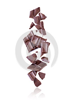 Broken porous dark chocolate fall down on white background