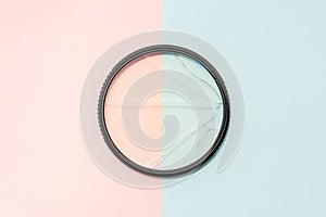 Broken protective glass for camera lens filter on colored background