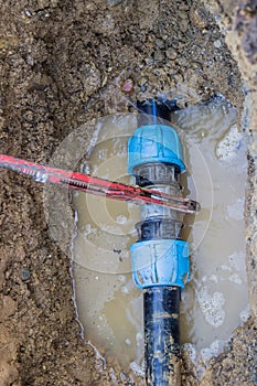 Broken pvc pipe in trench with wrench leaks water 2