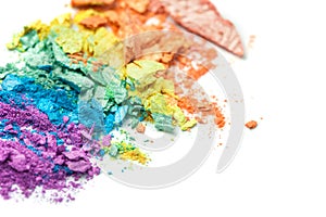 A broken rainbow colored eye shadow smear, make up palette isolated on a white background.