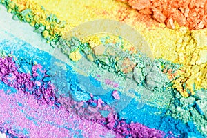 A broken rainbow colored eye shadow smear, make up palette isolated on a white background