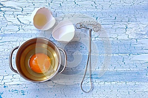 Broken raw egg in bowl