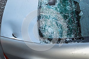 Broken rear glass of car, spread fragments of glass