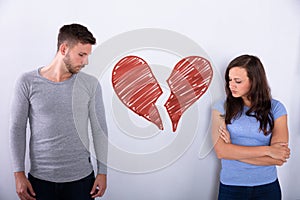 Broken Red Heart Between Sad Couple