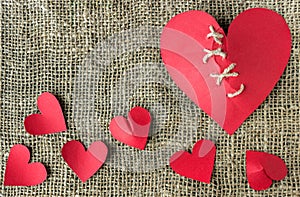 A broken red heart. Sewn thread. The concept of divorce.