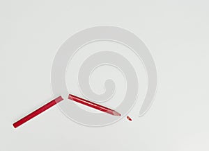 Broken red pencil on a white background