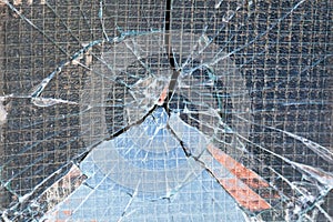 Broken reinforced glass window after a vandalism