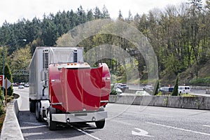 Broken on the road big rig red semi truck with an open hood