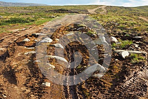 Broken road in the tundra. Off-road. Northern Arctic landscape