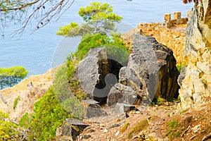 Broken rock on a mountain cliff in Lloret de Mar, Costa Brava, Spain