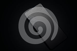 Broken screen glass of mobile smartphone on black background.