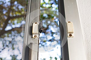 Broken security magnetic lock contact for mosquito wire screen window, Repair Room concept