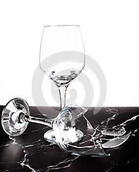 Broken shattered wine glass on marble background