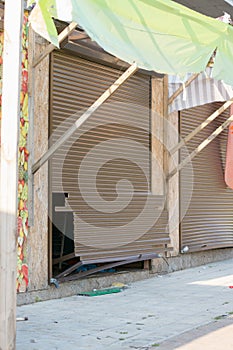 Broken shutters in a street vandals seaside shop