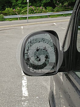 Broken side mirror car close-up. The consequences of the accident or an act of vandalism