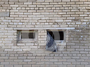 broken small windows of an old brick building