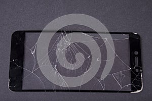 Broken smartphone glass on a black background